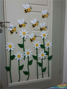 a door decorated with paper flowers and bees