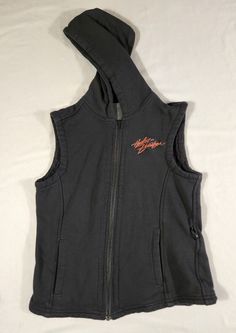 Harley Davidson women's sleeveless hooded full zip vest, size small. This vest is pre-owned. Please see pictures for approximate measurements. Feel free to reach out with any questions. Black Sleeveless Cotton Outerwear, Sporty Black Sleeveless Outerwear, Sleeveless Black Hoodie In Athleisure Style, Sleeveless Black Athleisure Hoodie, Black Hooded Vest For Streetwear, Black Hooded Sports Vest, Black Athleisure Vest For Streetwear, Fitted Hooded Vest For Streetwear, Black Cotton Hooded Vest