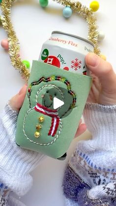 someone is holding up a cell phone case that has a christmas decoration on the front