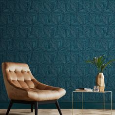 a chair and table in front of a blue wallpapered room with a plant