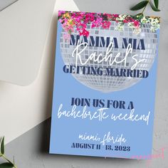 a blue and white flyer for a bachelor party with flowers in the middle, on top of an envelope