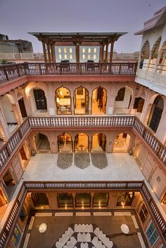 an aerial view of the inside of a large building with many windows and balconies