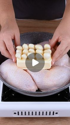 a person is cooking chicken in a pan on the stove