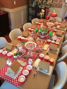 a table set up for a christmas party with lots of food and decorations on it