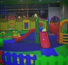 an indoor play area with slides and toys