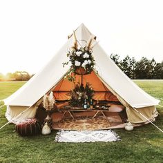 a teepee tent with flowers and plants in it