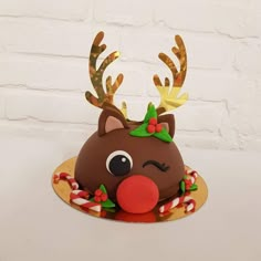 there is a cake decorated to look like a reindeer's head with antlers and candy canes on it