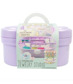 a purple plastic container with jewelry in it and a white handle on the top that says jewelery studio