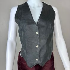 90s women's leather vest with snaps down the front.  Brand - Wilsons The Leather Experts Content - Outer Shell: 100% Leather, Lining: 100% Polyester Size - Labeled XL but measures like a modern women's Large so check measurements Shoulders - 12.75" across Chest - 20.25" pit to pit  Length - 18"-20.75" Condition - There is a white mark on the shoulder. There are scratches on the snaps. Women Leather Vest, Vest Outfits, White Mark, Leather Vest, Womens Vest, Modern Woman, Leather Women, Bathing Beauties, Womens Sizes