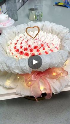 a cake in the shape of a basket on top of a table with lights around it