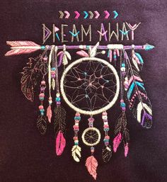 the back of a purple shirt with an embroidered dream catcher on it