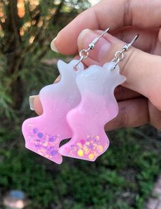 Created with resin, colorant, and glitter with a silicone mold. Fun squiggle shape with a soft pink color and large glitter pieces. Pendant is 1.5"L x 1"W. Overall length 3" Soft Pink Color, Rose Pale, White Glitter, Silicone Mold, Pink And White, Silicone Molds, Soft Pink, Pink Color, Jewelry Earrings Dangle