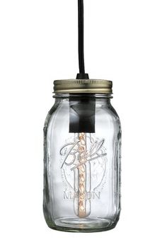 a glass mason jar with a black cord hanging from it