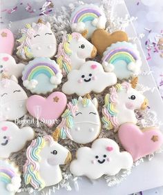 unicorn cookies are arranged on a plate with confetti