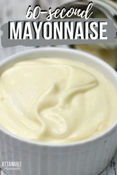 a white bowl filled with mayonnaise sitting on top of a wooden table