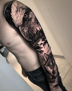 a man with an eagle and wolf tattoo on his arm