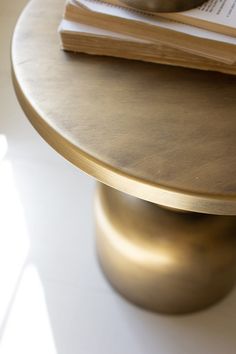 a close up of a table with a book on top of it and a coffee cup