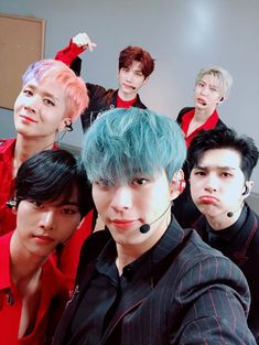 the group of young men are posing together for a photo with their hair dyed blue