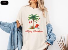 Celebrate Christmas with a tropical twist! 🌺🎄 This fun and festive Tropical Christmas Shirt is perfect for those who want to trade snowflakes for sunshine. Featuring vibrant palm trees, tropical colors, and holiday cheer, it's great for anyone who dreams of a warm, beachy Christmas. Whether you're on vacation or just bringing a little island spirit to your festivities, this shirt is sure to stand out! HOW TO ORDER 1. Please ensure that you check and review all photos for important ordering det Hawaiian Christmas Party Outfit, Christmas Beach Shirts, Beach Holiday Graphic Print T-shirt, Tropical Christmas Shirt, Beachy Palm Tree Print T-shirt For Summer, Beachy T-shirt With Palm Tree Print For Beach, Christmas Palm Tree, Hawaiian Christmas, Christmas Party Outfit