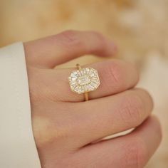 a close up of a person's hand with a ring on it