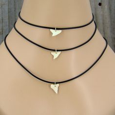 Great Size for Boys and Girls  New Small White Shark Tooth Necklace Pendant on Black Silicone Rubber Cord  Choice of 14, 15, 16, 17, 18, 19 Inch length Made for You and Shipped daily from Florida USA To determine the best size for you, use a string or similar material. Wrap it around your neck and down to where you would like the tooth to lay. Stretch the string out on a yard stick or tape measure and select the size nearest your choice. More Shark Jewelry here - https://www.etsy.com/shop/GrassS Shark Jewelry, Shark Tooth Necklace, Tooth Necklace, Surfer Necklace, Shark Tooth, White Sharks, Shark Teeth, Shell Jewelry, Florida Usa