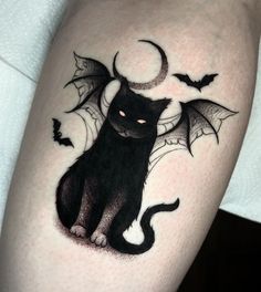 a black cat with bats on it's legs