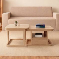 a living room with a couch, coffee table and bookshelf on the floor