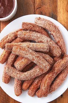 churros on a white plate with dipping sauce