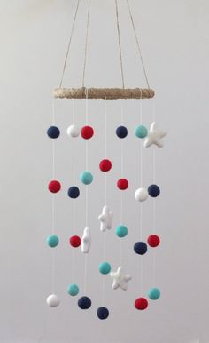 a mobile with stars and balls hanging from the ceiling