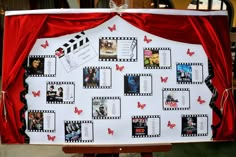 a white board with red curtains and pictures attached to it's sides, in front of a red curtain