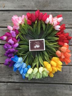 colorful tulips are arranged in a circle with a photo on the front and side