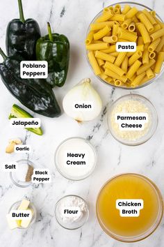 ingredients to make pasta in bowls on a marble counter top with peppers, garlic and pepper paste