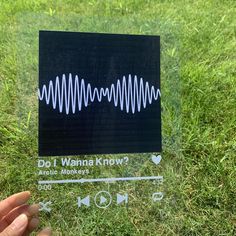 someone is holding up a sticker with an image of a sound wave on it