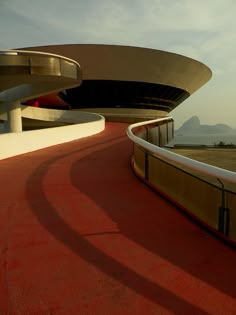 the curved walkway is next to an empty parking lot