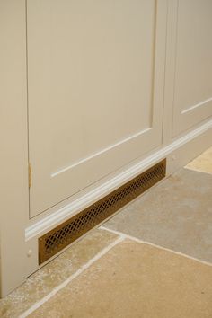 a close up of a door with a grate in the floor next to it