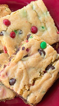 a red plate topped with cookies and candy bars