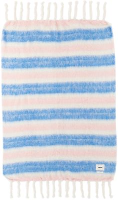 a blue and pink striped blanket with white pom poms