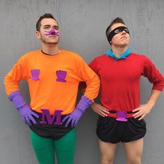 two people in costumes standing next to each other with their hands on their hipss