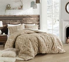 a bedroom with a bed, chair and rugs on the floor in front of a window