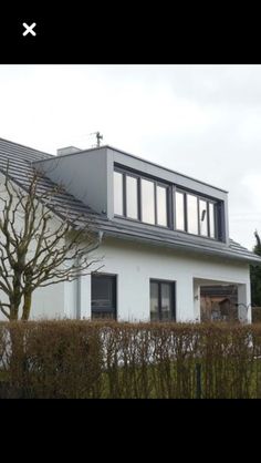 a large white house sitting on top of a lush green field