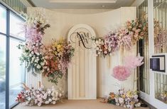 an entrance decorated with flowers and greenery