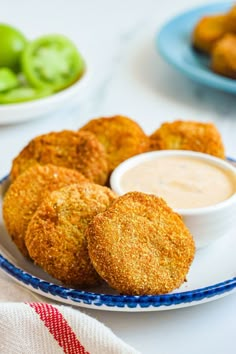 some fried food on a plate with dipping sauce