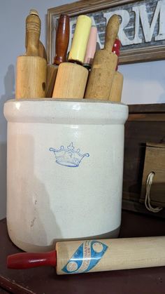 a wooden baseball bat sitting on top of a table next to a white container filled with wood shavings