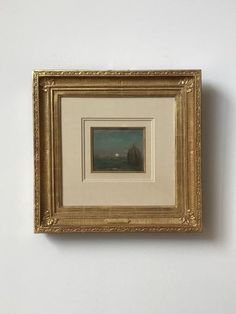 a painting hanging on the wall with a white and gold frame around it's edges