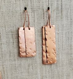 Minimal Hand Hammered Copper Rectangle Earrings--2 Sizes, Copper Dangle Earring, Steampunk, Hammered Copper Rectangle Drop Earrings Design update if you've bought these before! I now have two sizes of these fantastic hammered solid copper rectangle earrings. When my first batch of these solid copper rectangular discs arrived in my mailbox they were smaller than I had envisioned for hand stamping words; however, I soon realized they'd look great hand hammered and minimally hung from earwires. I hammered the blanks in an imperfect manner. Each pair is different, unique to you. Each of us have been hammered by life's adversities but can choose to see the beauty in how we overcome. Allow beauty to emerge from your challenges. What do you think? Two sizes now. Longer 2.25" and shorter 1.75" fro Rectangular Linear Earrings For Gift, Handmade Rectangular Copper Earrings, Rectangular Copper Earrings With Ear Wire, Rectangle Earrings, Earrings Design, Hammered Copper, Baby Bag, Metal Stamping, Mailbox