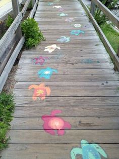 a wooden walkway with colorful drawings on it