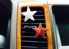 an orange and white car air vent with two stars on it