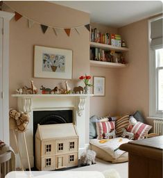 a living room filled with furniture and a fire place in front of a book shelf