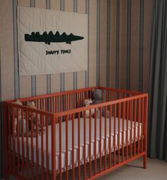 a baby crib in a room with striped walls