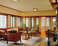 a living room filled with furniture and lots of windows